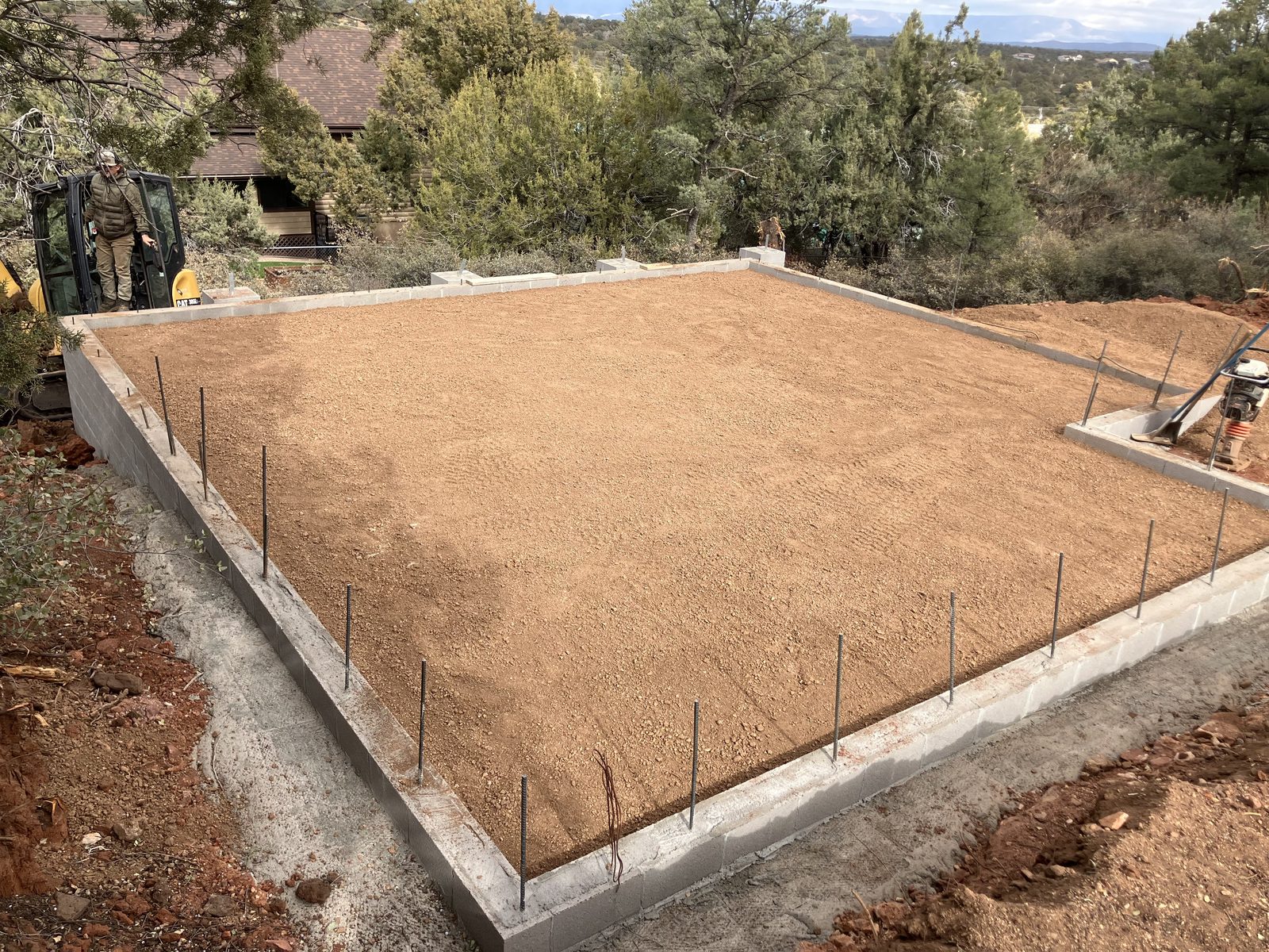 Compacted subgrade and foundation walls before plumbing on a custom hillside home in Payson, Arizona
